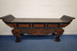 AN ORIENTAL EBONISED AND RED HARDWOOD ALTER TABLE, with heavily carved chinoiserie decoration,