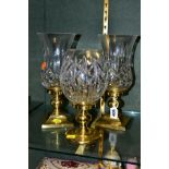 A PAIR OF WATERFORD CRYSTAL HURRICANE CANDLE HOLDERS, Lismore pattern glass shade on brass square