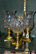 A PAIR OF WATERFORD CRYSTAL HURRICANE CANDLE HOLDERS, Lismore pattern glass shade on brass square