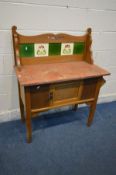 AN EDWARDIAN MARBLE TOP WASHSTAND, with a tiled back, width 91cm x depth 46cm x height 111cm