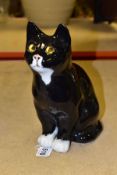 A WINSTANLEY POTTERY CAT, black and white colourway with yellow eyes, signed to the base, height