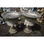 A PAIR OF COMPOSITE CAMPANA GARDEN URNS, with fruiting vine decoration and male masks, on a separate