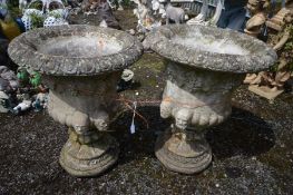 A PAIR OF COMPOSITE CAMPANA GARDEN URNS, with fruiting vine decoration and male masks, on a separate