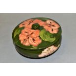 A MOORCROFT POTTERY COVERED POWDER BOWL, Hibiscus pattern on green ground, impressed backstamp and