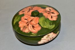 A MOORCROFT POTTERY COVERED POWDER BOWL, Hibiscus pattern on green ground, impressed backstamp and