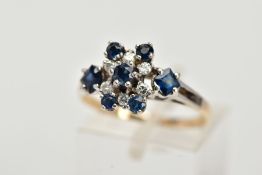 A YELLOW METAL SAPPHIRE AND DIAMOND CLUSTER RING, set with a central claw set, circular cut blue