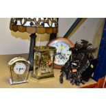 A LATE 20TH CENTURY TIFFANY STYLE LEADED GLASS TABLE LAMP AND FOUR CLOCKS, height of lamp 45.5cm,