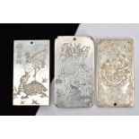 THREE WHITE METAL ORIENTAL PLAQUE PENDANTS, each tested as zinc, each depicting different scenes