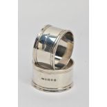 TWO SILVER NAPKIN RINGS, plain polished design reeded rims, one engraved with an initial 'M' the