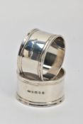 TWO SILVER NAPKIN RINGS, plain polished design reeded rims, one engraved with an initial 'M' the