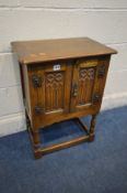 A SMALL OAK GOTHIC TWO DOOR CABINET, width 51cm x depth 33cm x height 68cm