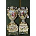 A PAIR OF EARLY 20TH CENTURY POTSCHAPPEL PORCELAIN TWIN HANDLED FLORAL ENCRUSTED VASES ON PLINTHS,