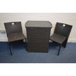 A BLACK GLASS TOP RATTAN EFFECT PATIO TABLE enclosing two chairs (3)