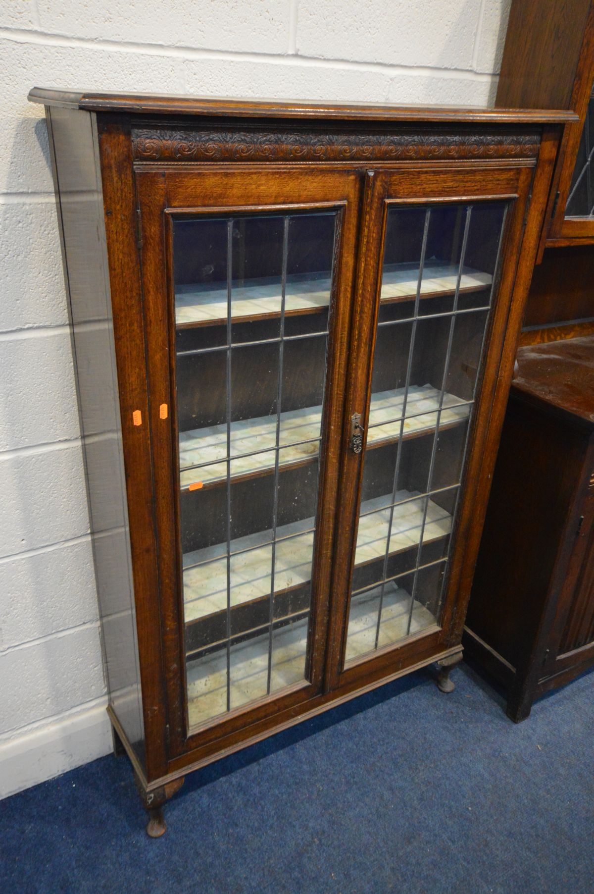 AN EARLY 20TH OAK LEAD GLAZED BOOKCASE, the double doors enclosing three adjustable shelves, on - Image 3 of 3