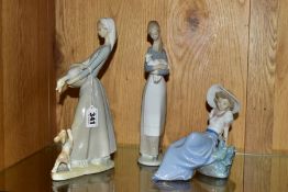 TWO LLADRO FIGURES OF GIRLS AND ANOTHER BY NAO, comprising no 4866 'Girl with Goose and Dog',