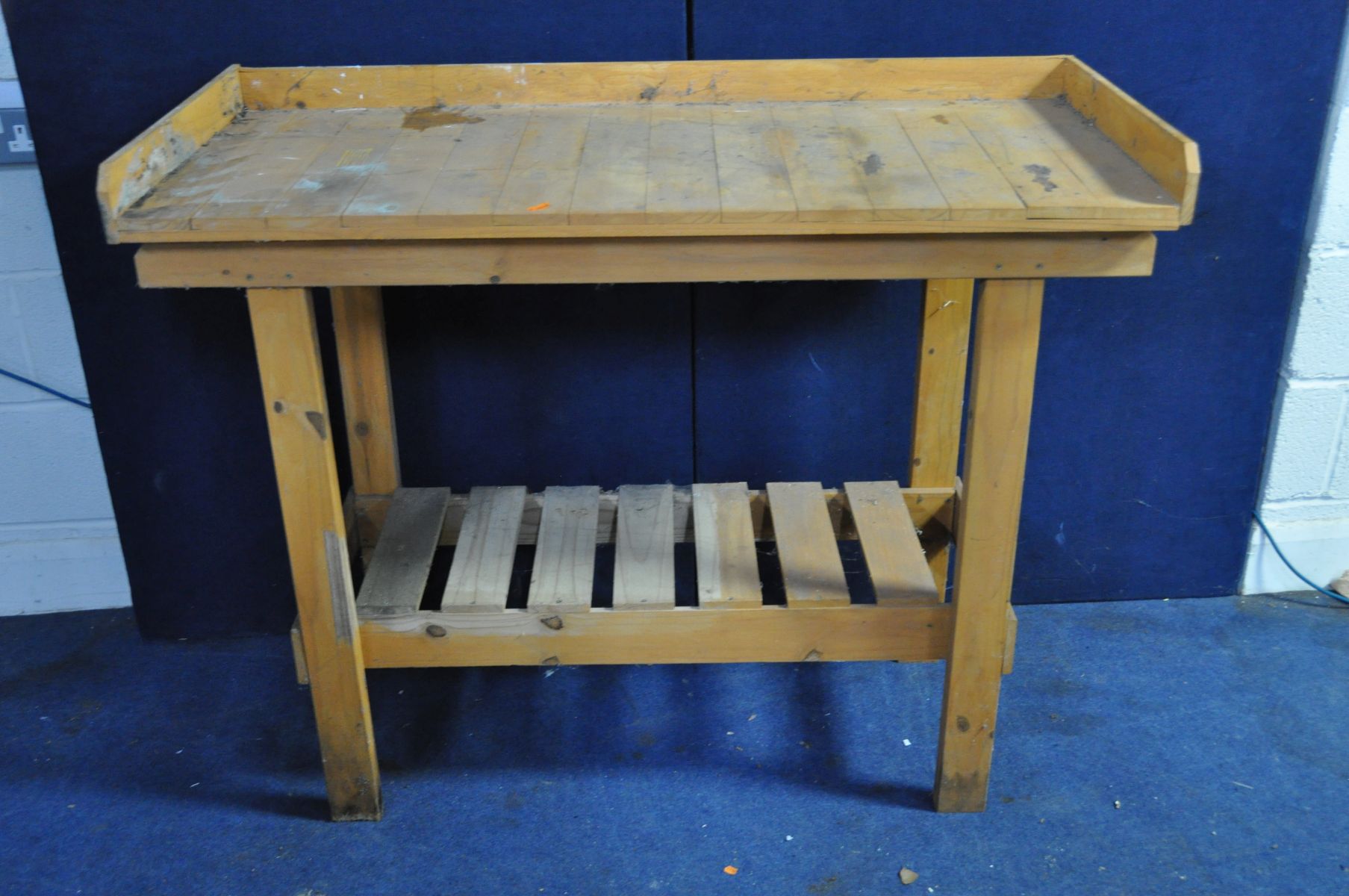 A MODERN PINE GREENHOUSE POTTING TABLE with slatted under shelf