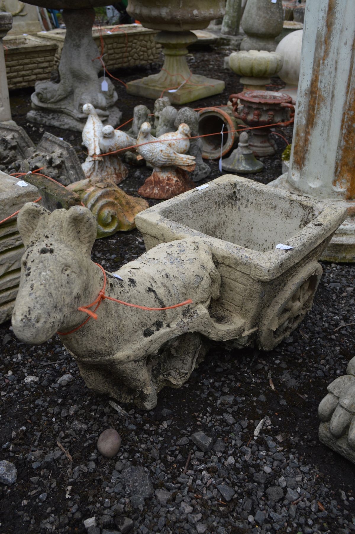 A COMPOSITE GARDEN FIGURE of a hound holding a shield, along with a composite planter of a donkey - Image 3 of 3