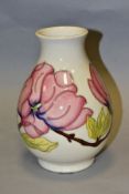 A MOORCROFT POTTERY BALUSTER VASE DECORATED WITH PINK MAGNOLIA ON A CREAM GROUND, painted WM in