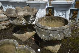 TWO COMPOSITE GARDEN URNS, on of an acanthus leaf