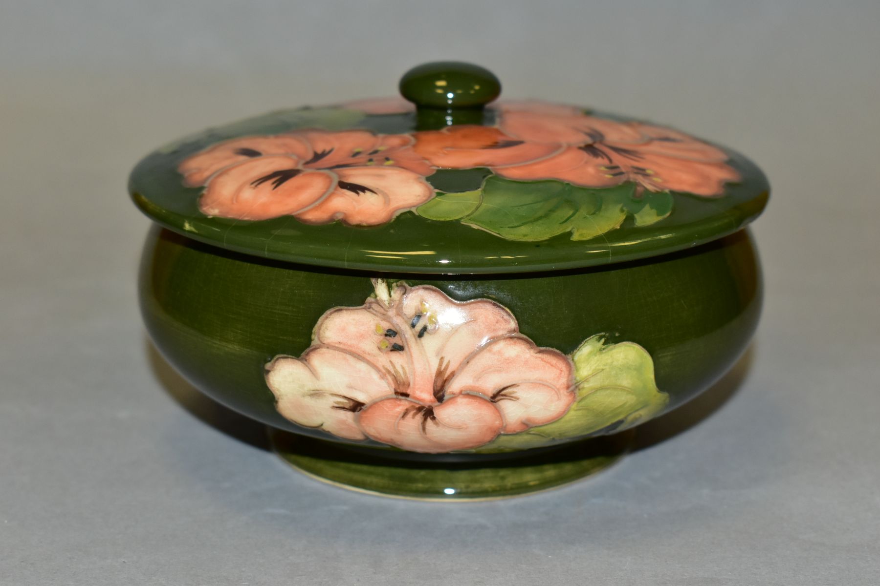 A MOORCROFT POTTERY COVERED POWDER BOWL, Hibiscus pattern on green ground, impressed backstamp and - Image 3 of 4
