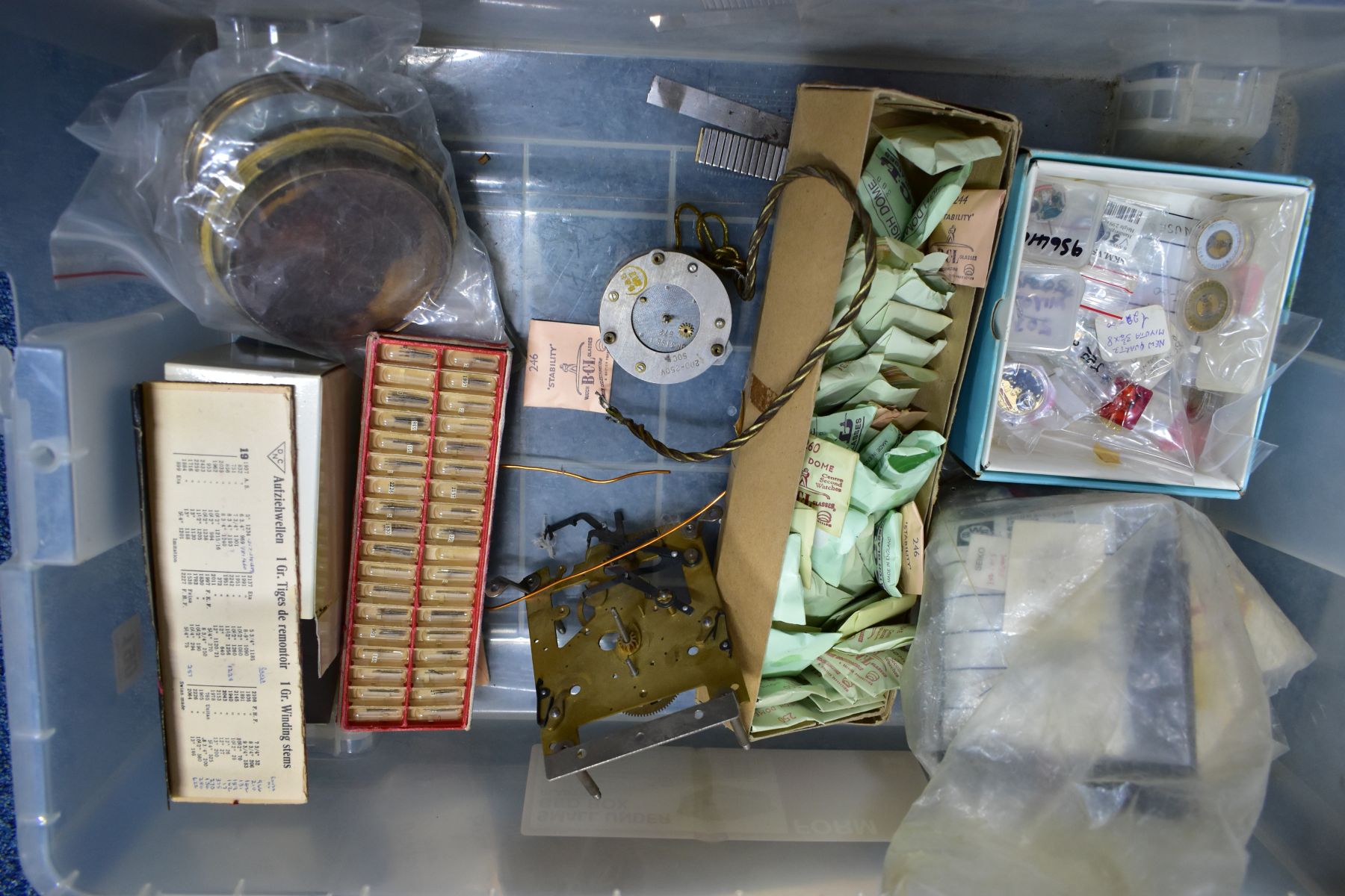 FOUR BOXES OF CLOCK AND WATCH PARTS, to include a box of clock weights, pendulum weights, hands, - Image 4 of 5