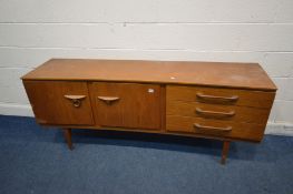 A TEAK 6FT CONCAVE SIDEBOARD, a bank of three drawers, the top drawer with a green baize lined