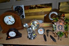 A SMALL GROUP OF SEVEN CLOCKS AND A MODERN BAROMETER, the clocks include an Edwardian mahogany,