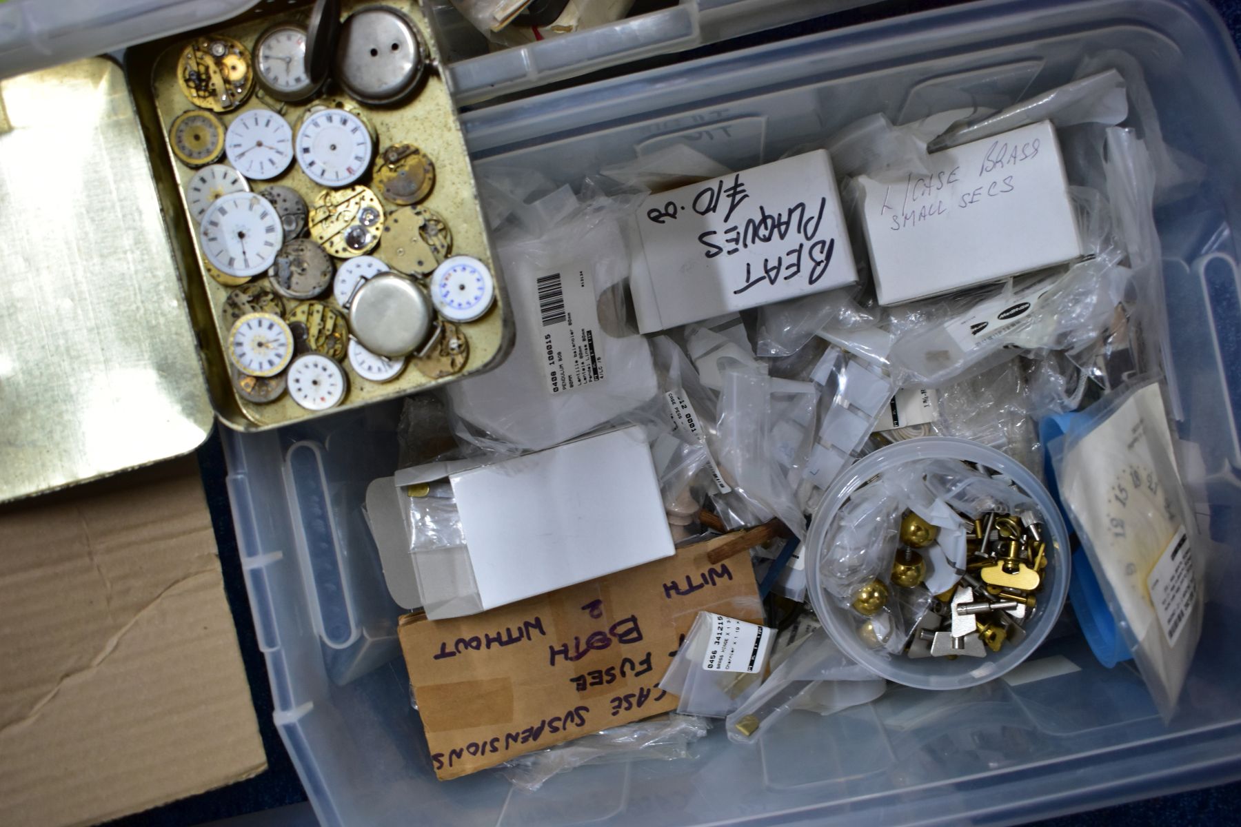 FOUR BOXES OF CLOCK AND WATCH PARTS, to include a box of clock weights, pendulum weights, hands, - Image 5 of 5