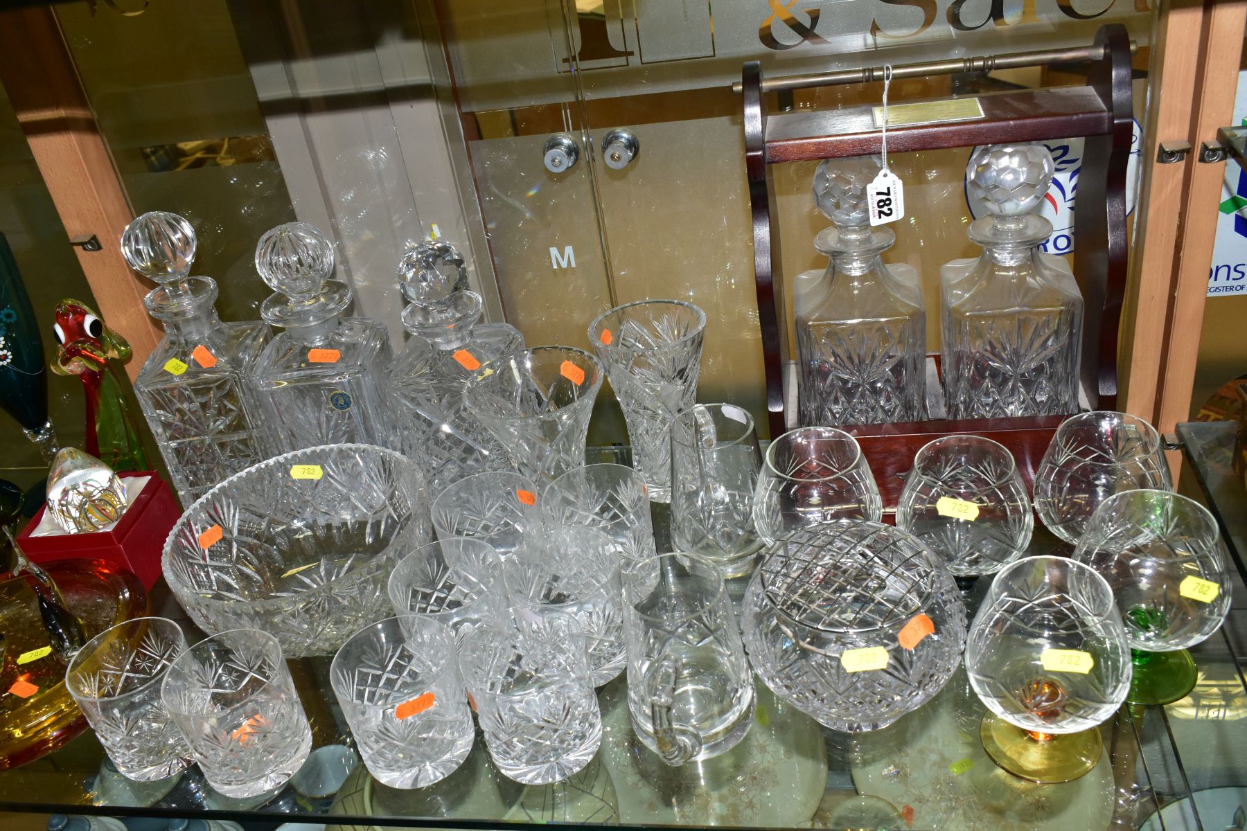 A GROUP OF COLOURED AND CUT GLASSWARES, to include a two bottled tantalus, total height 34cm, with