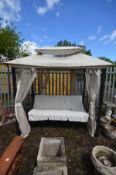 A METAL GARDEN SWINGING SEAT, rectangular frame with canopy, drapes and 67inch bench with adjustable