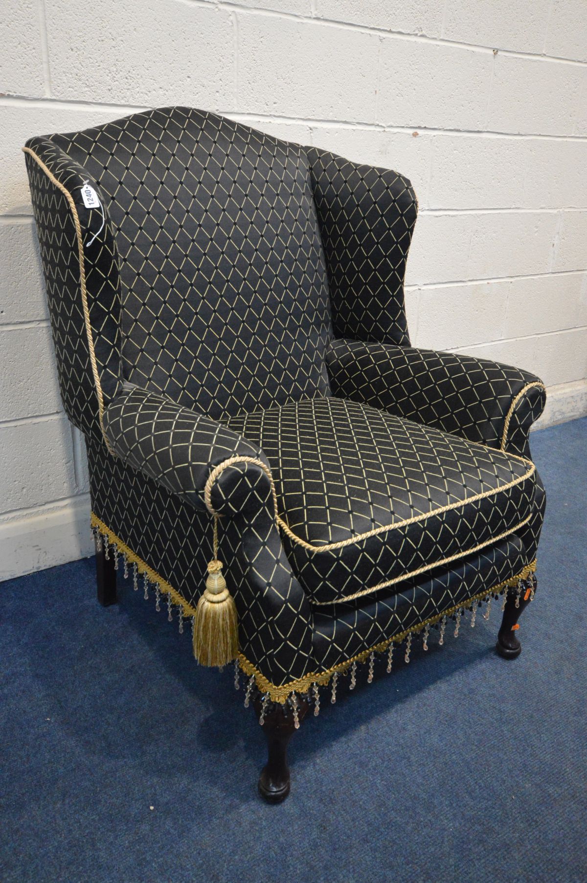 A GEORGIAN STYLE WINGBACK ARMCHAIR, with black ground and patterned upholstery, width 80cm x inner - Image 2 of 3