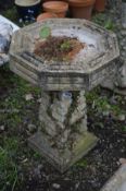 A COMPOSITE OCTAGONAL BRICK EFFECT BIRD BATH, on a separate base, diameter 43cm x height 61cm (crack