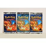 A SEALED POKEMON BASE SET BLACK TRIANGLE ERROR PRINTED BOOSTER PACK, with two other sealed Base