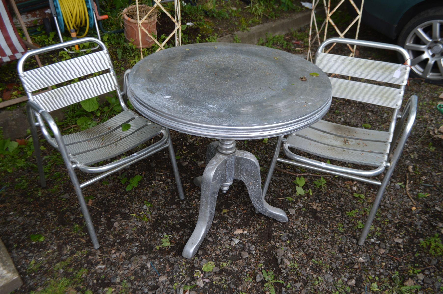 A STAINLESS STEEL CIRCULAR PEDESTAL GARDEN TABLE, diameter 79cm x height 75cm and two aluminium