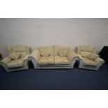 A CREAM UPHOLSTERED THREE PIECE SUITE comprising a settee, width 209cm and a pair of armchairs (3)