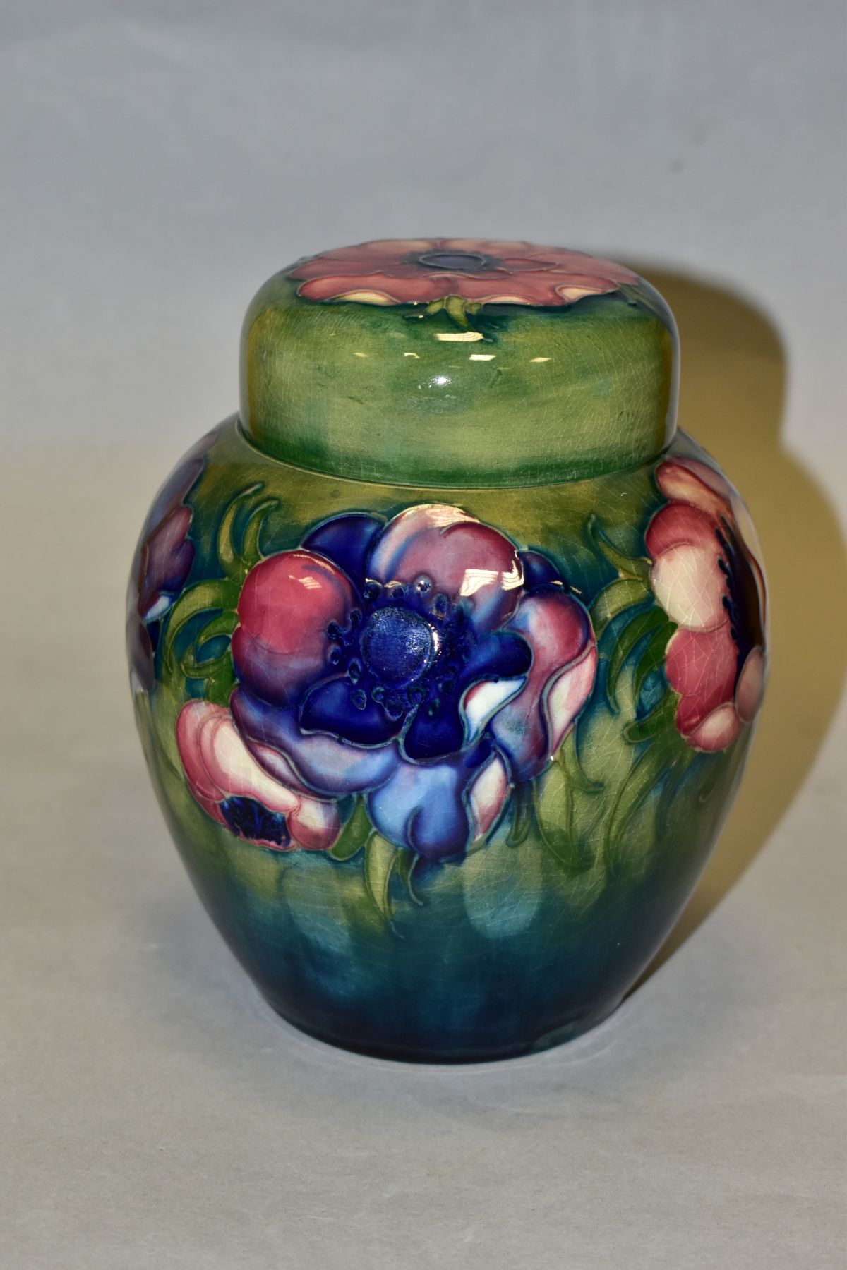 A MOORCROFT POTTERY GINGER JAR AND COVER, decorated in pink/blue anemone on a green ground, - Image 2 of 6