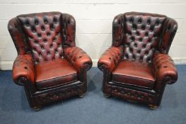 A PAIR OF OXBLOOD LEATHER BUTTON BACK WINGBACK ARMCHAIRS, with later feet together with a similar