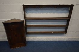 A GEORGIAN OAK HANGING CORNER CUPBOARD with a single door enclosing two fixed shelves together