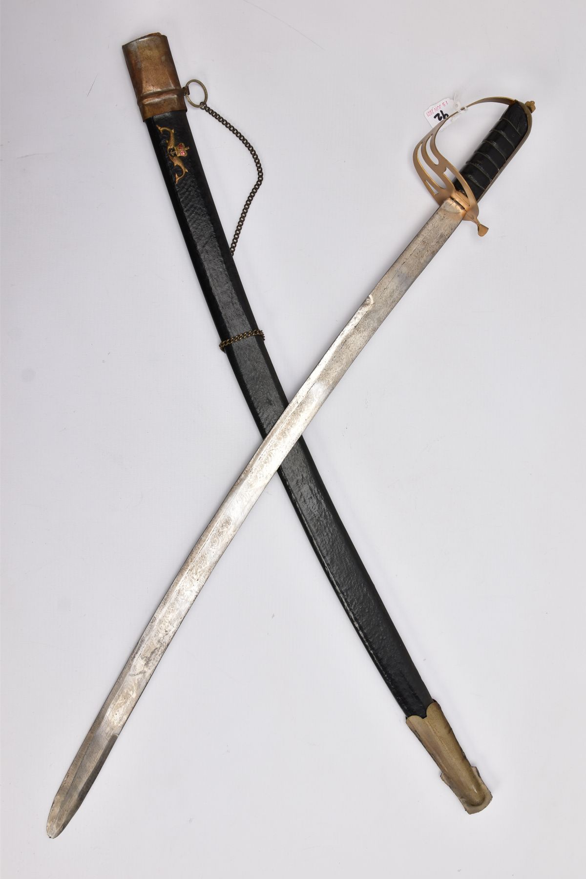 A LOW QUALITY SWORD AND SCABBARD, blade is curved and approximately 80cm in length, the blade is