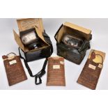 A BOX CONTAINING TWO WWII ERA HOME FRONT GAS MASKS in boxes and three sets of anti gas eye