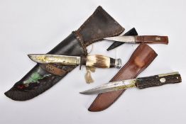 A BOX CONTAINING TWO CAMPING STYLE KNIVES AND SCABBARDS fake bone handles, etc and a Scottish 'Sgian