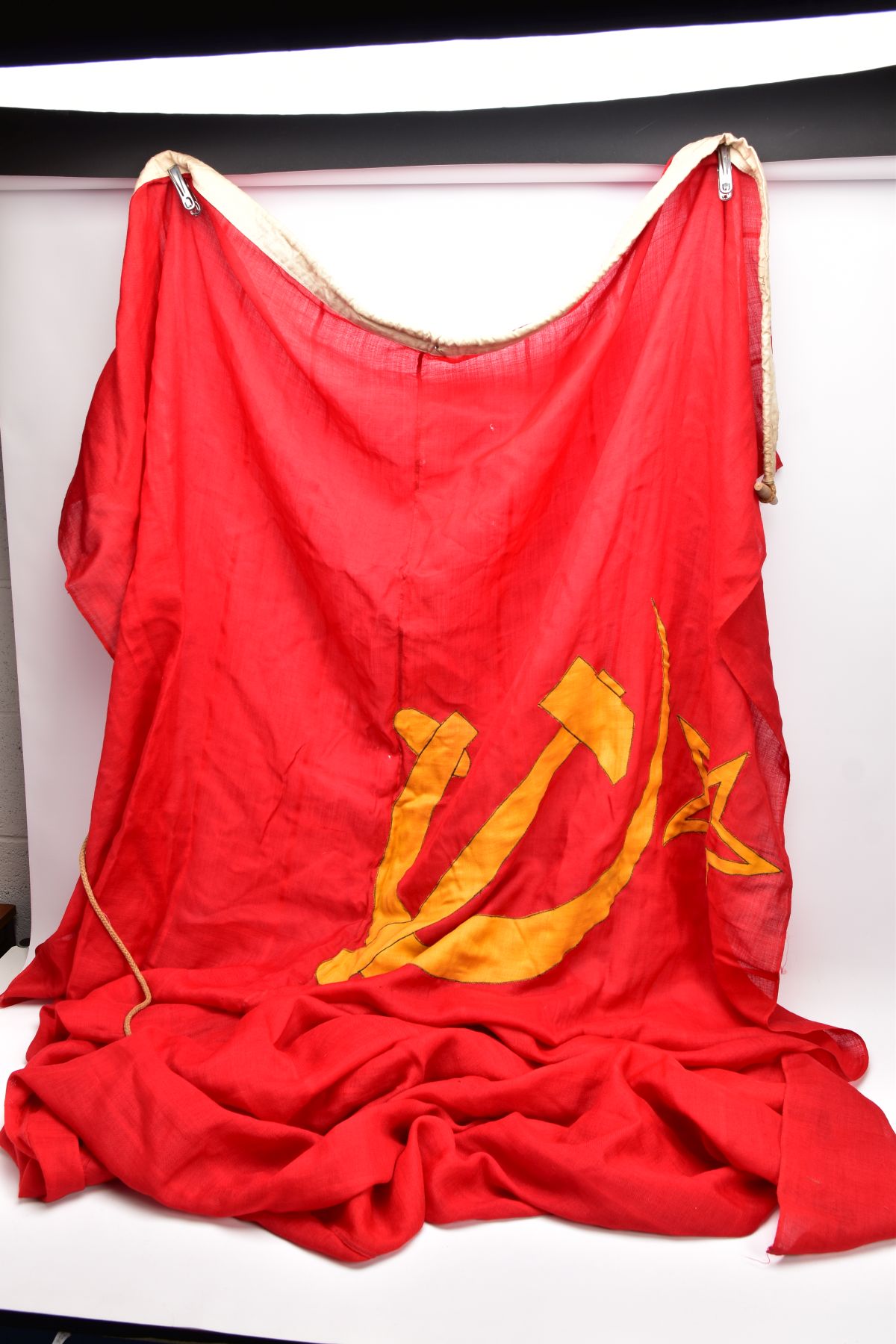 A LARGE RED/GOLD COLOURED RUSSIAN (CCCP) FLAG, approximately six feet x eight feet, corded and bound