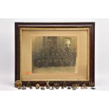 A LARGE GLAZED FRAME WITH A WWI PERIOD PHOTO OF A COMPANY OF SOLDIERS, in uniform, believed RAMC,