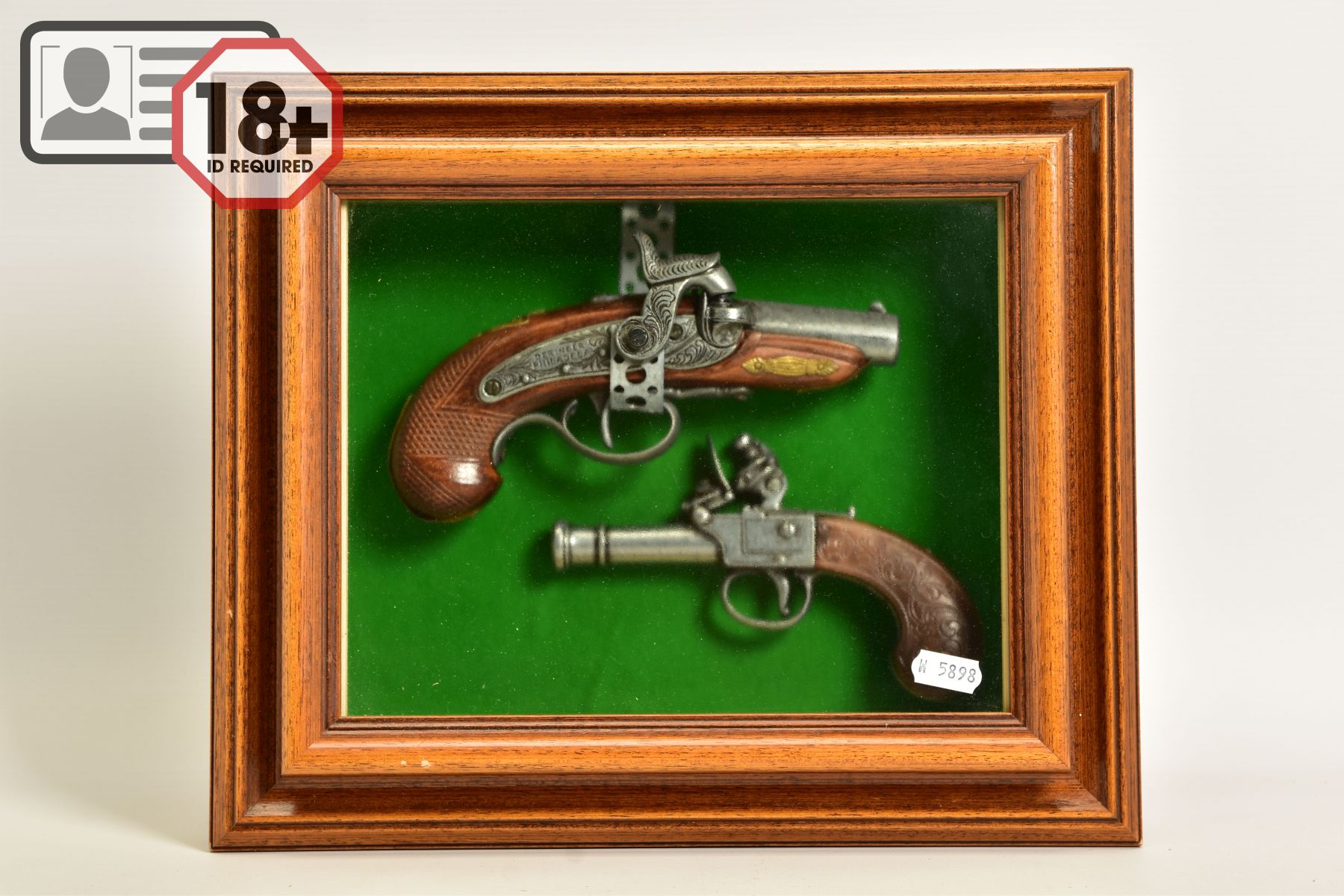 A NEATLY FRAMED DISPLAY CASE containing a white metal replica of a percussion American derringer and