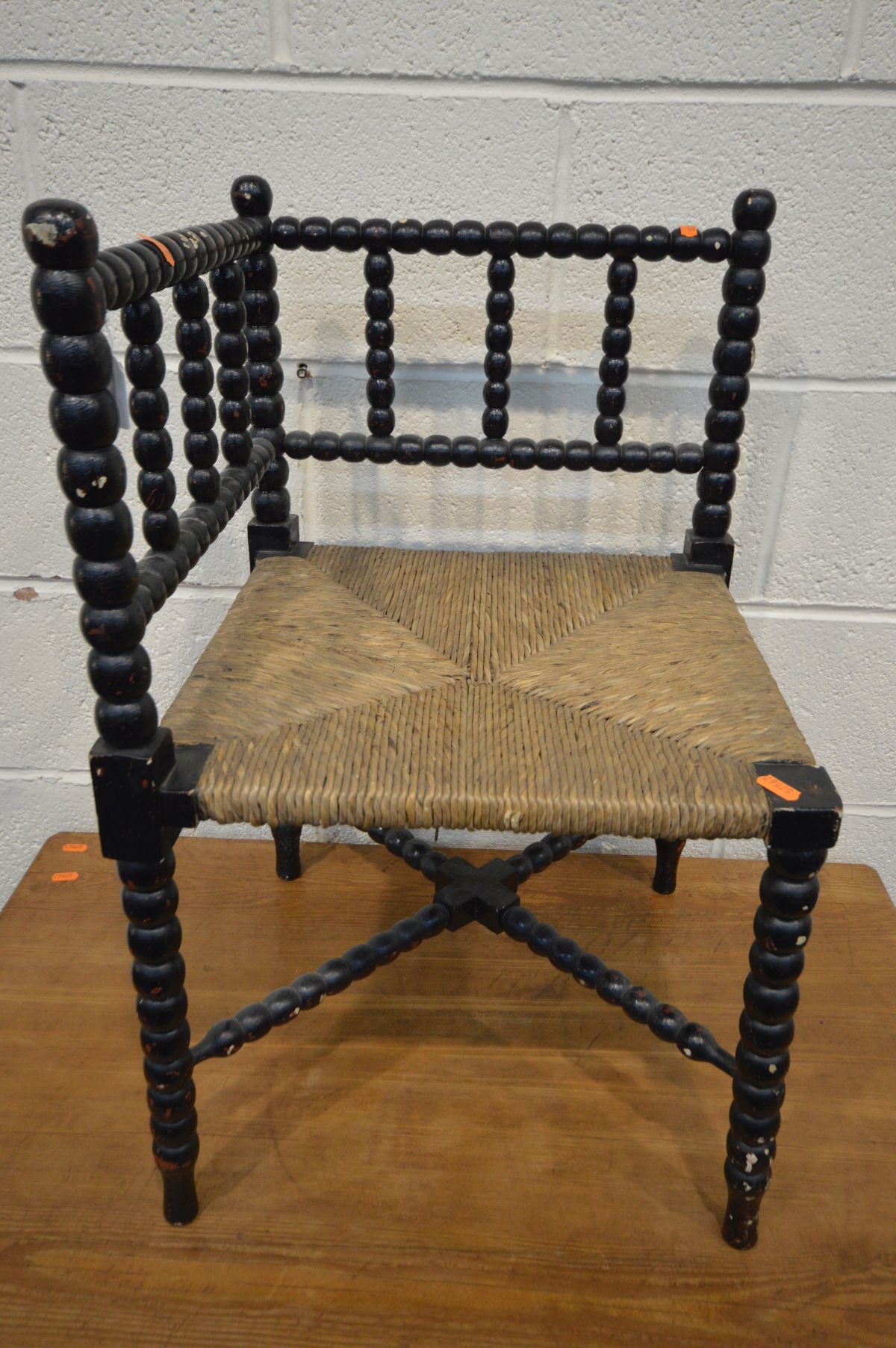 AN ARTS AND CRAFTS EBONISED BOBBIN TURNED CORNER CHAIR, with a rush seat (over painted) - Image 2 of 2