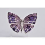 A WHITE METAL ENAMELLED BUTTERFLY BROOCH, designed with purple guilloche enamelled wings, fitted