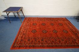 A MODERN SERAPI STYLE RED GROUND RUG with a multi strap border, 293cm x 20cm together with an oak