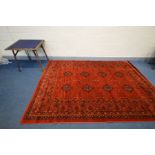 A MODERN SERAPI STYLE RED GROUND RUG with a multi strap border, 293cm x 20cm together with an oak