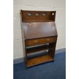 AN ARTS AND CRAFTS OAK SLIM BUREAU, with a raised back with pierced heart decoration, fall front