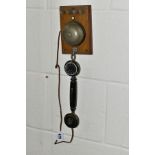 AN EARLY 20TH CENTURY BUTLER'S INTERCOM, comprising of a wooden board with bell, push button, four